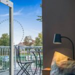 Blick vom Ferienobjekt auf ein Riesenrad und Wasser, Favorent Ferienwohnungsvermietung.